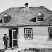 Image 1: Two window roof dormers atop woodframe building