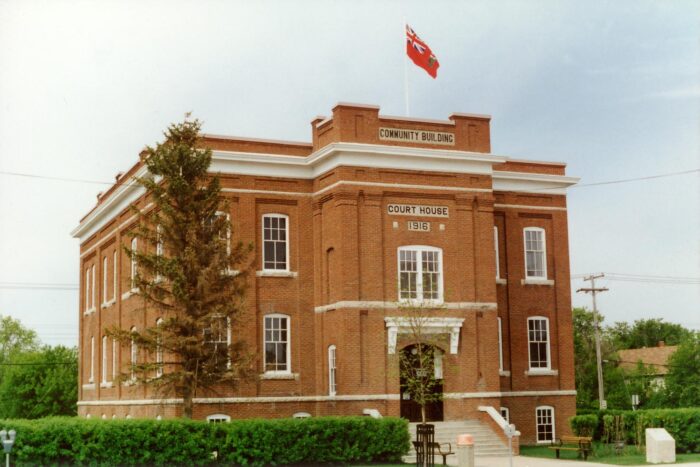 The Court House in The Pas. The facade reads “COMMUNITY BUILDING,” “COURT HOUSE” AND “1916.”