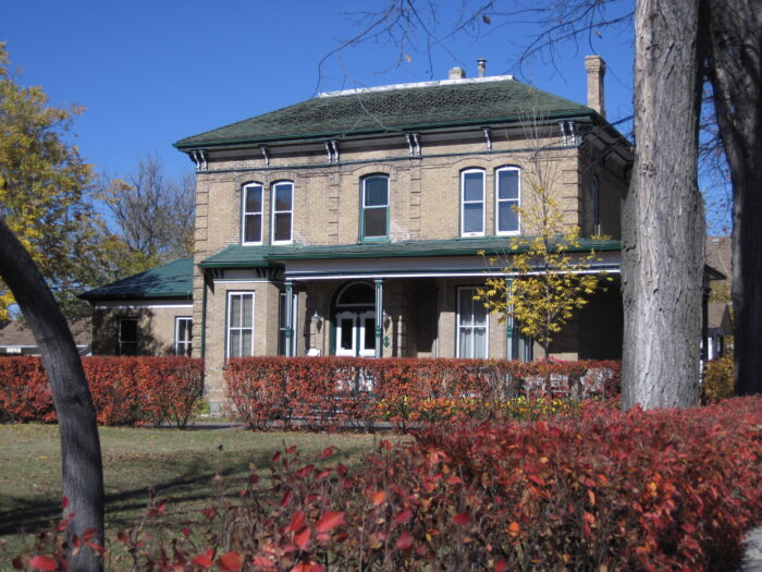 Fleming House house behind a hedge.