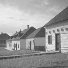 Image 4: A row of 4 single-storey wooden buildings